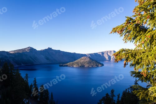 Preview: End Of The Day At Wizard Island In Crater Lake National Park With A Deep Blue Color In The Water