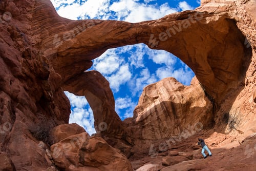 Preview: Woman Standing At The Base Of Double Arch To Give Size Perspective Of This Amazing Feature In Utah