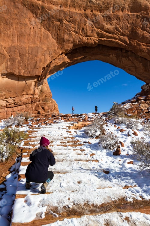 Preview: Moab, Utah - December 03: Woman Photographing North Window With People At The Base For Size