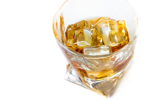 Preview: Close Up Of A Tumbler Glass With Straight Kentucky Bourbon Served On The Rocks Isolated On A White