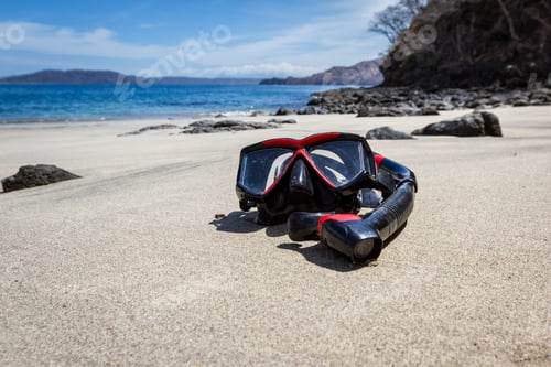 Preview: Wide Angle Close Up Of A Snorkeling Mask And Tube On A Relaxing Beach With Blue Water In The