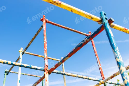 Preview: Old Rusty Playground Equipment Jungle Gym With Peeling Paint Against A Blue Sky Selective Focus