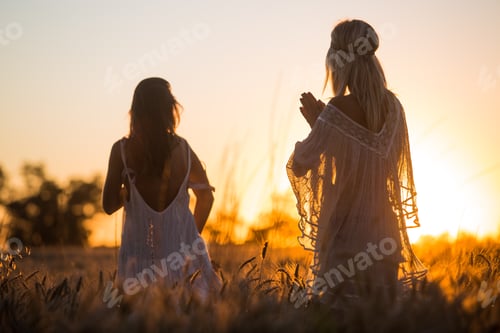 Preview: Young Girls Playing And Watching Sunset In The Fields At Golden Hour Surrounded By Corn Plants.