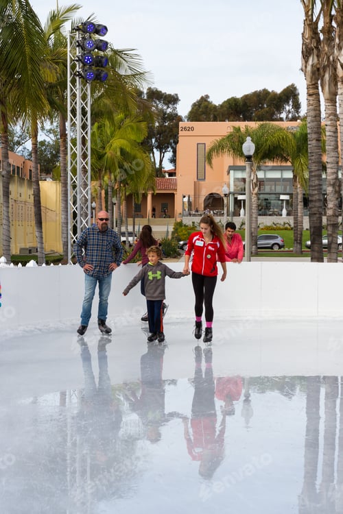 Preview: San Diego, California - November 26: Teenage Girl Teaching Children How To Ice Skate In Southern