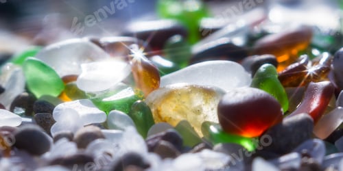 Preview: Close Up Of A Group Of Shiny Pieces Of Sea Glass On The Beach Using A Star Filter To Obtain A
