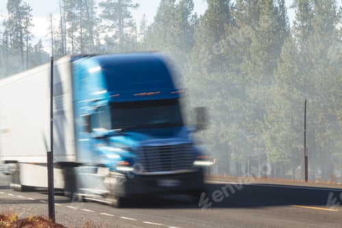 Preview: Diamond Lake, Oregon - November 06: Tractor Trailer Driving On Highway 230 With Smoke From Forest