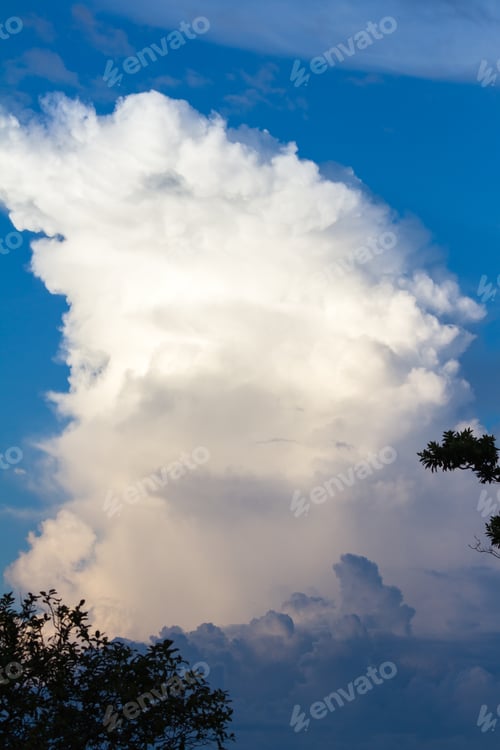 Preview: Towering Cloud Reaching Up Towards The Sky As The Sun Brightens It Before It Sets