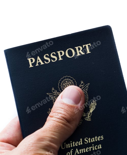Preview: Close Up Of A Hand Holding An American Passport Over A White Background