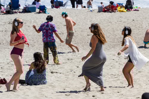 Preview: San Luis Obispo, California - Young Adults Having Fun And Dancing On The Beach Wearing Headphones