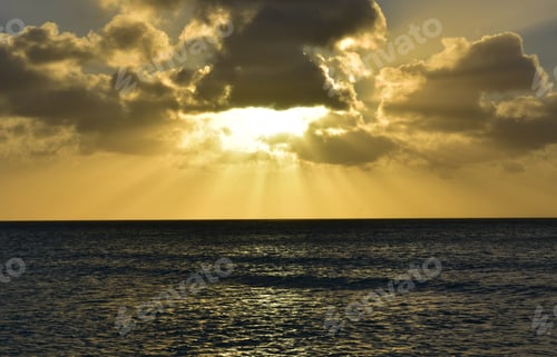 Preview: Gorgeous Orange Sunset With Dark Clouds Over The Ocean.