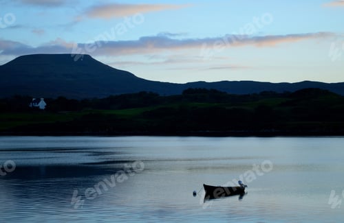Preview: Solitary Silhouetted Dinghy Boat On Loch Dunvegan In Scotland.