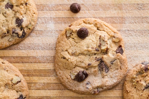 Preview: Close Up Of A Home Made Chocolate Chip Cookie On A Wooden Cutting Board