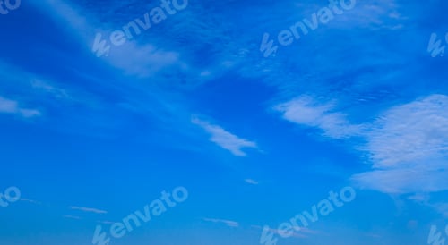 Preview: A Bright Blue Sky Background With A Few Wispy Clouds.