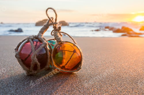 Preview: Sunset In The Oregon Coast With Colorful Glass Floats On A A Sandy Beach