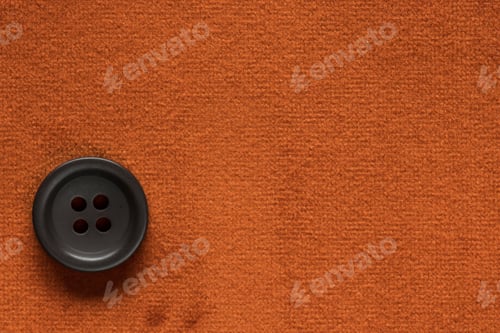 Preview: Clothes Sewing Button On An Orange Fabric Swatch Background