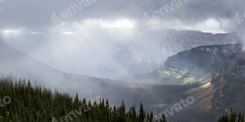 Preview: Serene Landscape In Glacier Np Montana With A Dense Fog Clinging To The Mountains And Warm Sunshine