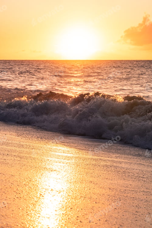 Preview: Sun Setting Over The Pacific Ocean With Waves Crashing On The Sand In The Foreground. Colorful Sun