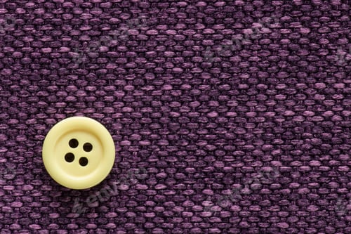 Preview: Clothes Sewing Button On A Purple Fabric Swatch Background