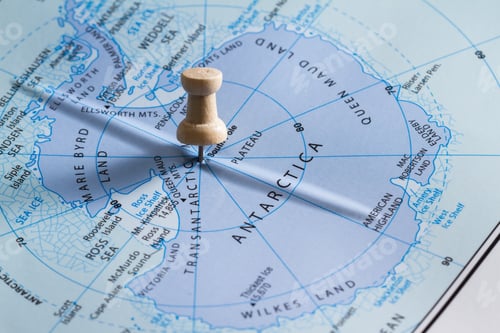 Preview: Close Up Of Map With The Word Antarctica In Focus With A Push Pin Marking The Spot