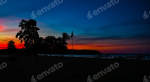 Preview: The American Flag Silhouetted Against The Sunset On Little Bay Off The Chesapeake Bay In Virginia