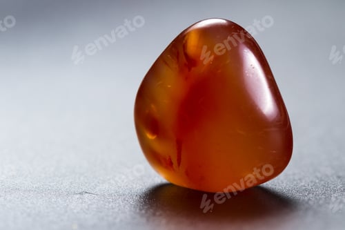 Preview: Close Up Of A Polished Piece Of Carnelian Isolated On A Black Background