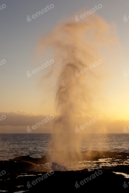 Preview: Setting Sun Illuminates Spout Of Water From Lava Rocks On Coast Of Kauai