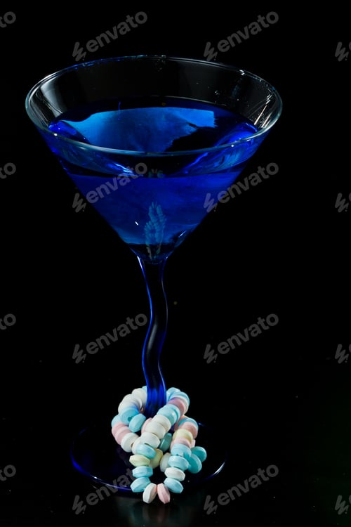 Preview: Blue Cocktail Isolated On A Black Background With A Candy Necklace Wrapped Around It