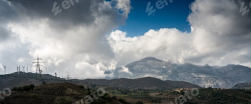 Preview: Scenic View Of Electricity Pylons On Mountain Landscape Against Cloudy Sky, Crete, Greece