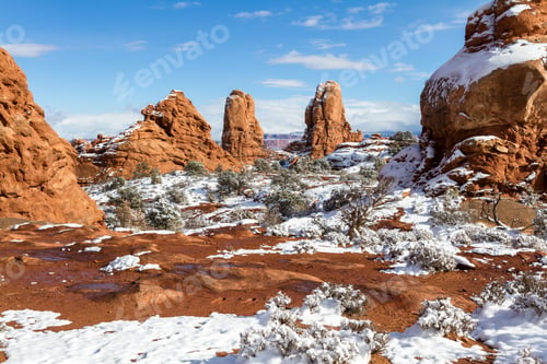 Preview: Snow Covered Ground With Beautiful Red Rock Features With A Blue Sky In Arches National Park