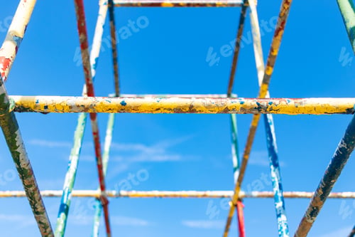 Preview: Old Rusty Playground Equipment Jungle Gym With Peeling Paint Against A Blue Sky Selective Focus