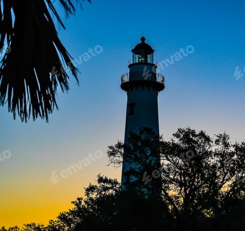 Preview: The St. Simons Island Lighthouse Silhouetted As The Morning Sun Begins To Light The Sky With Trees