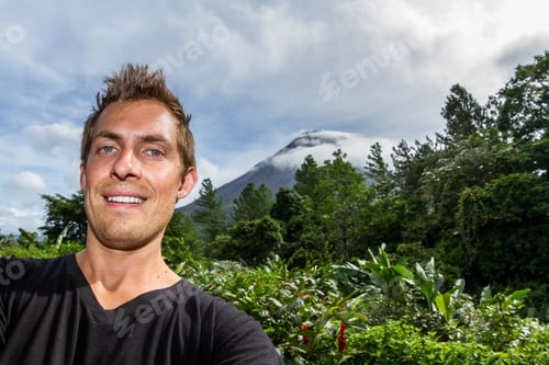 Preview: Young Man Taking A Self Portrait With The Famous Arenal Volcano In The Background