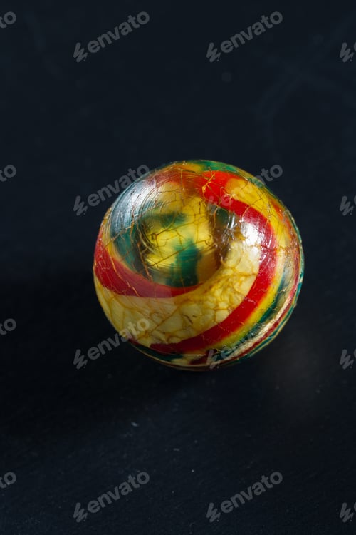 Preview: Close Up Of A Small Antique Bouncy Ball On A Dark Background