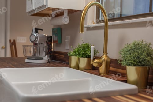 Preview: Close Up Detail Shot Of A Kitchn Sink With Gold Faucet