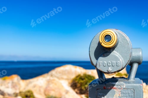 Preview: Tourist Telescope Overlooking A Rocky Coastal Ocean View