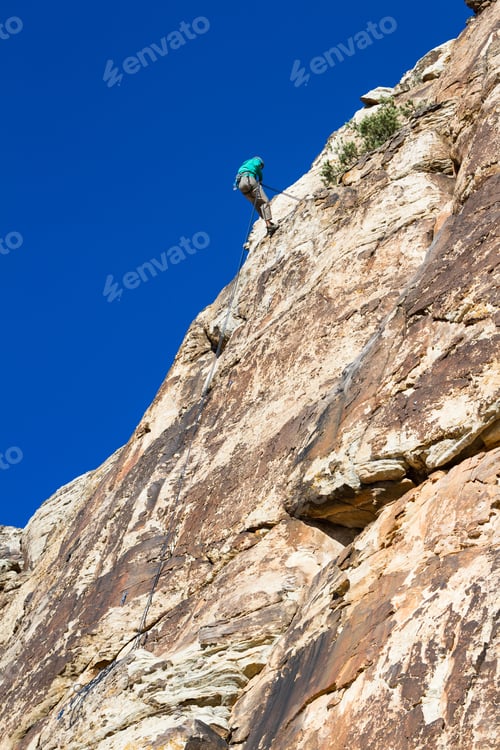 Preview: Young Man Repelling Down A Sandstone Cliff In Youth Western Utah