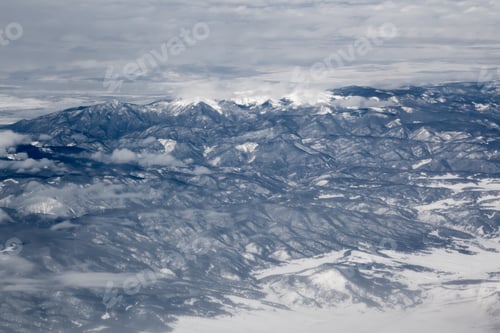 Preview: Snowy Landscape From Above Through Clouds