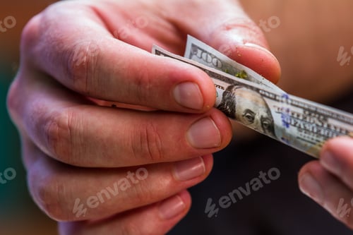 Preview: Close Up Of Stuffing And Rolling A Fake One Hundred Dollar Bill Cannabis Joint