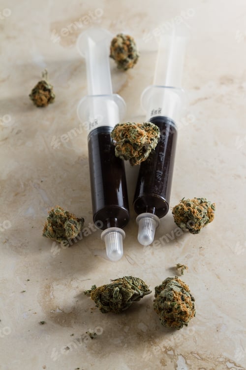 Preview: Close Up Of An Oil Made From The Essential Oil Of The Cannabis Hemp Plant With Buds Next And Around