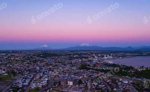 Preview: Aerial View Of The City Of Puerto Montt At Dusk, The Osorno And Calbuco Volcanoes Are Visible In