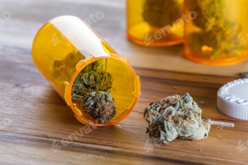 Preview: Close Up Of Cannabis Buds With Orange Prescription Bottles On A Wooden Table