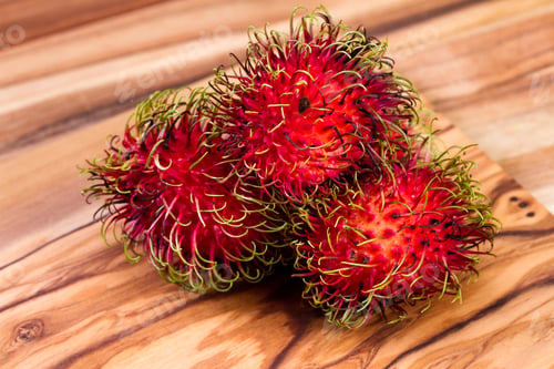 Preview: Close Up Of A Group Of Rambutan On A Wooden Table