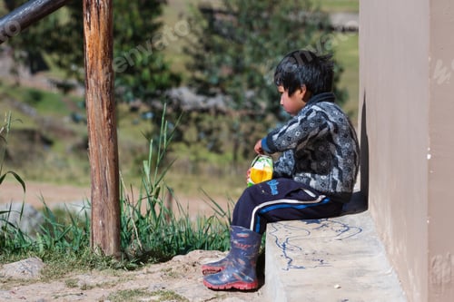 Preview: Chinchero Peru -May 18 : Young Andean Boy With A Large Carton Of Fruit Juice. May 18 2016