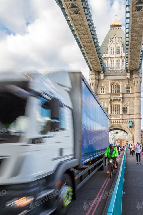 Preview: London - September 05 2019: Cyclists Riding Across The Thames With Heavy Vehicle Traffic, London