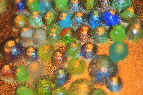 Preview: Colorful Marbles Photographed Through A Glass Sheet. With Light Coming From Various Directions