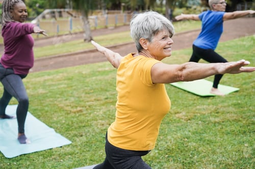 Preview: Senior People Doing Yoga Class Keeping Distance At City Park - Focus On Center Woman Face