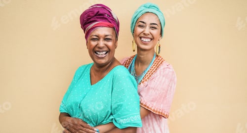 Preview: Happy African Mother And Daughter Hugging Each Other While Wearing Traditional Dresses - Focus On