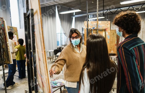 Preview: Young Students Painting Inside Art Room Class Wearing Safety Masks - Focus On Teacher Face