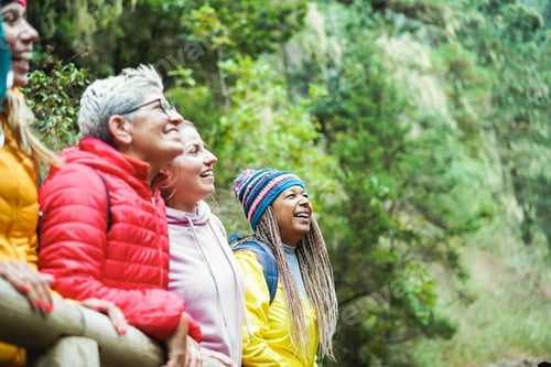 Preview: Multiracial Women Having Fun Exploring Nature On Trekking Day In Mountain Forest - Focus On African