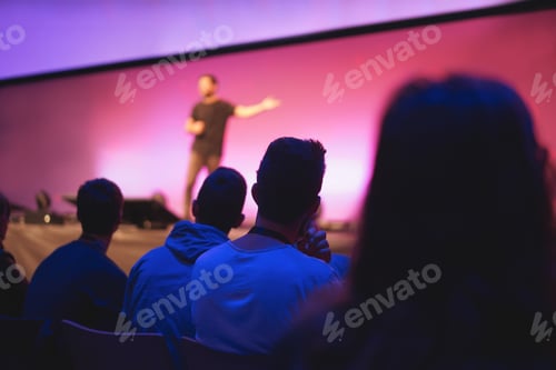 Preview: Speaker Giving Conference Speech To Audience At Public Event - Focus On Right Man Back
